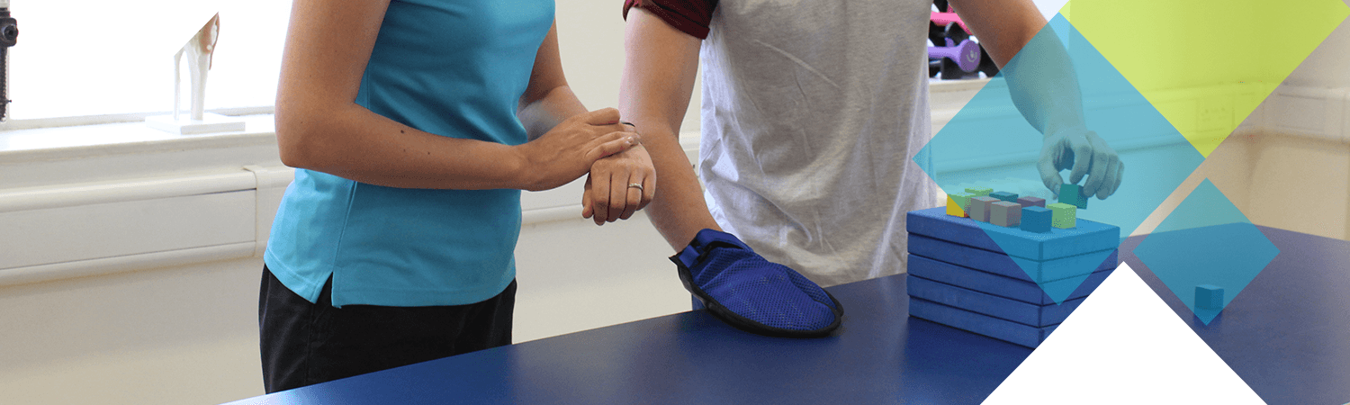 CIMT patient stacks blocks during timed challenge