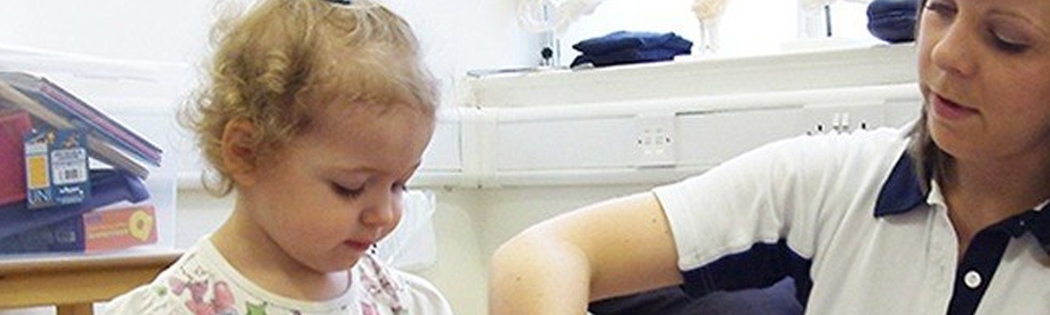 Ellie during therapy with a CIMT physio Ellie during therapy with a CIMT physio