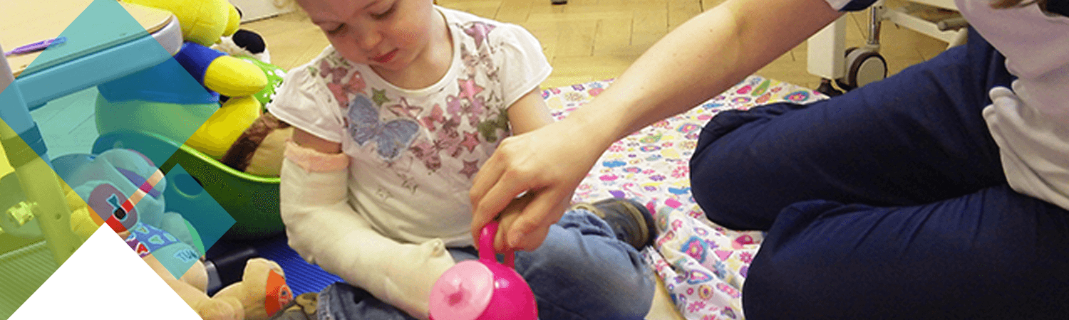 Ellie with her arm in a cast playing