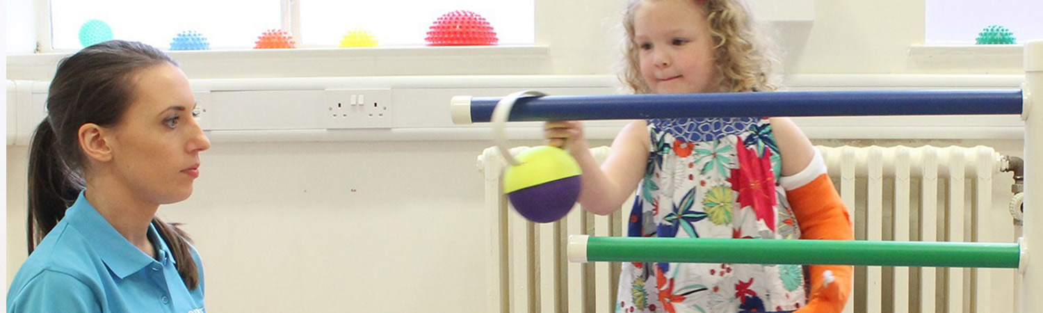 Child putting hooped balls onto a stick