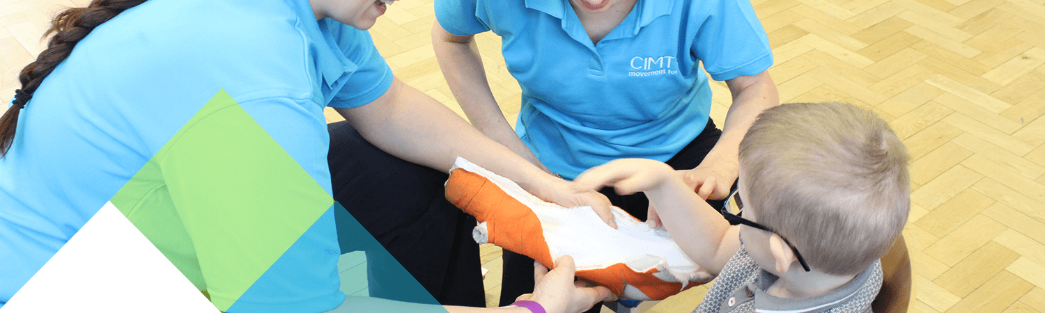 CIMT patient sits happily as his arm cast is applied