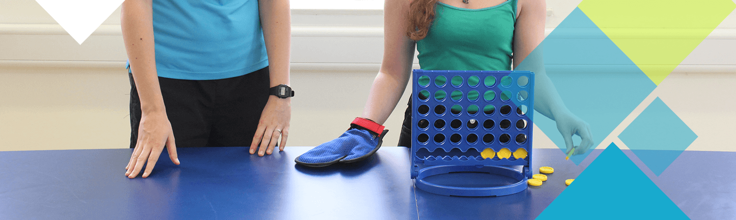 A CIMT patient with their physiotherapist using Connect4 as a tool