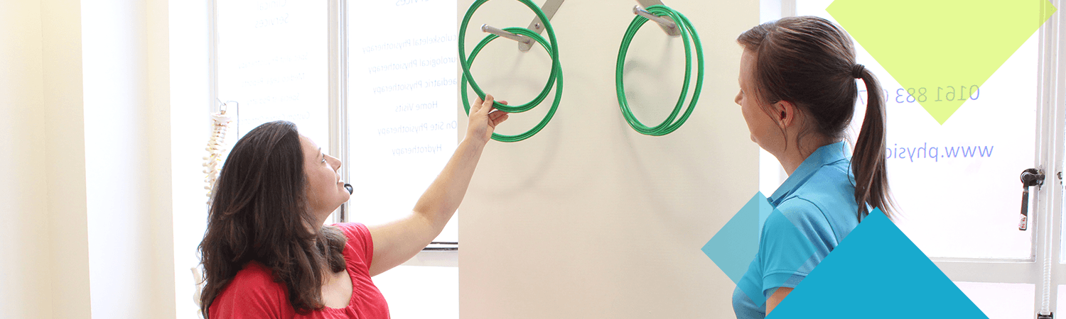 CIMT physiotherapist aids a patient during a task