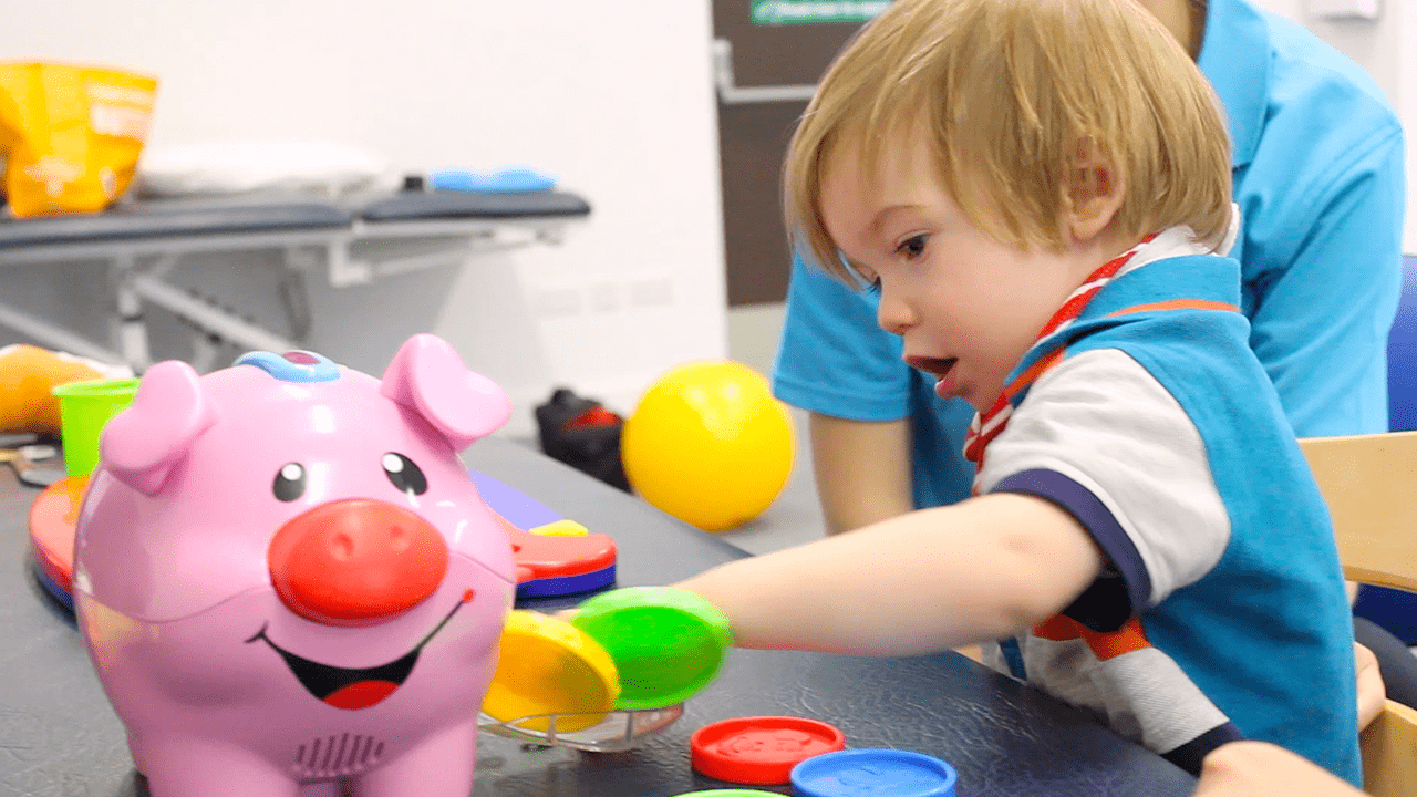 Alistair playing with play-doh during treatment at CIMT