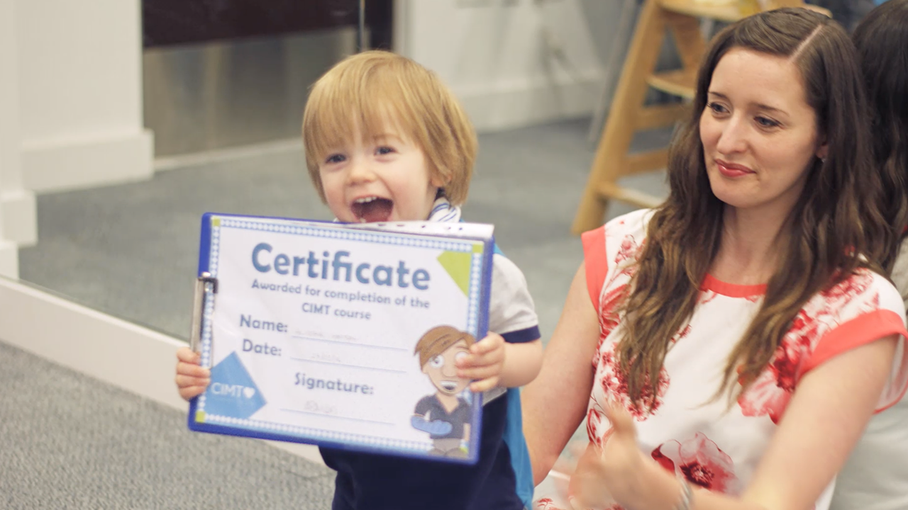 Alistair smiling with his CIMT certificate award.