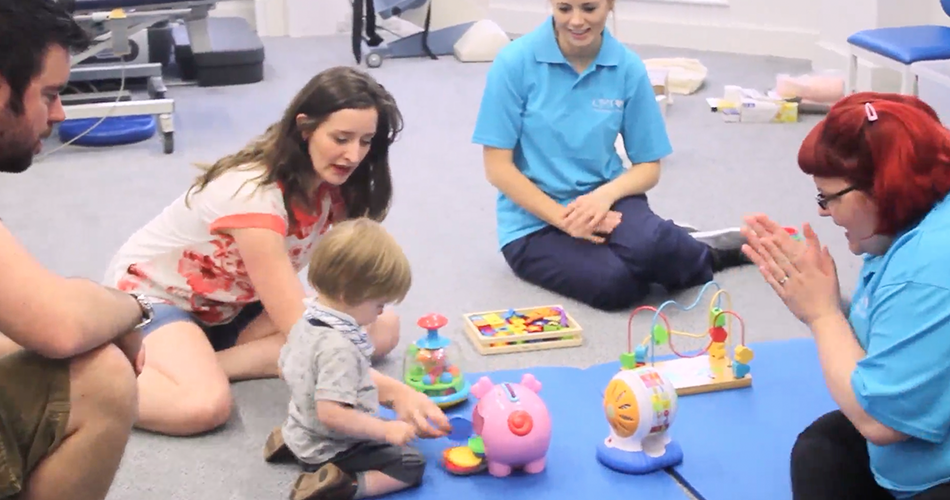 Nikki, the CIMT therapist sat smiling with Alistair.