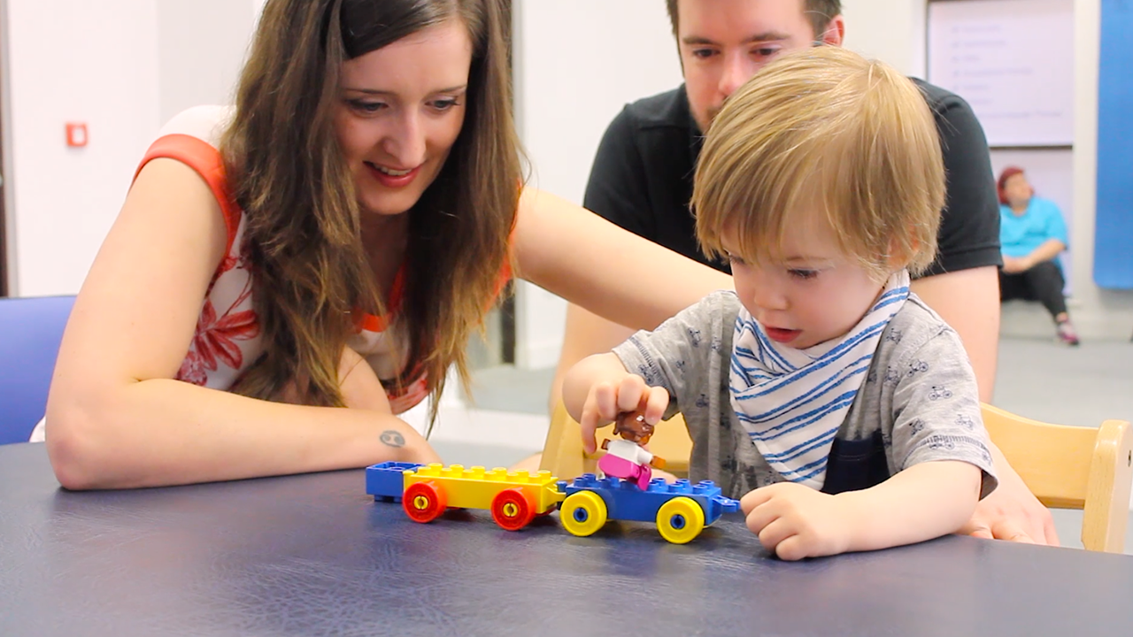 Alistair playing with his mum and dad.