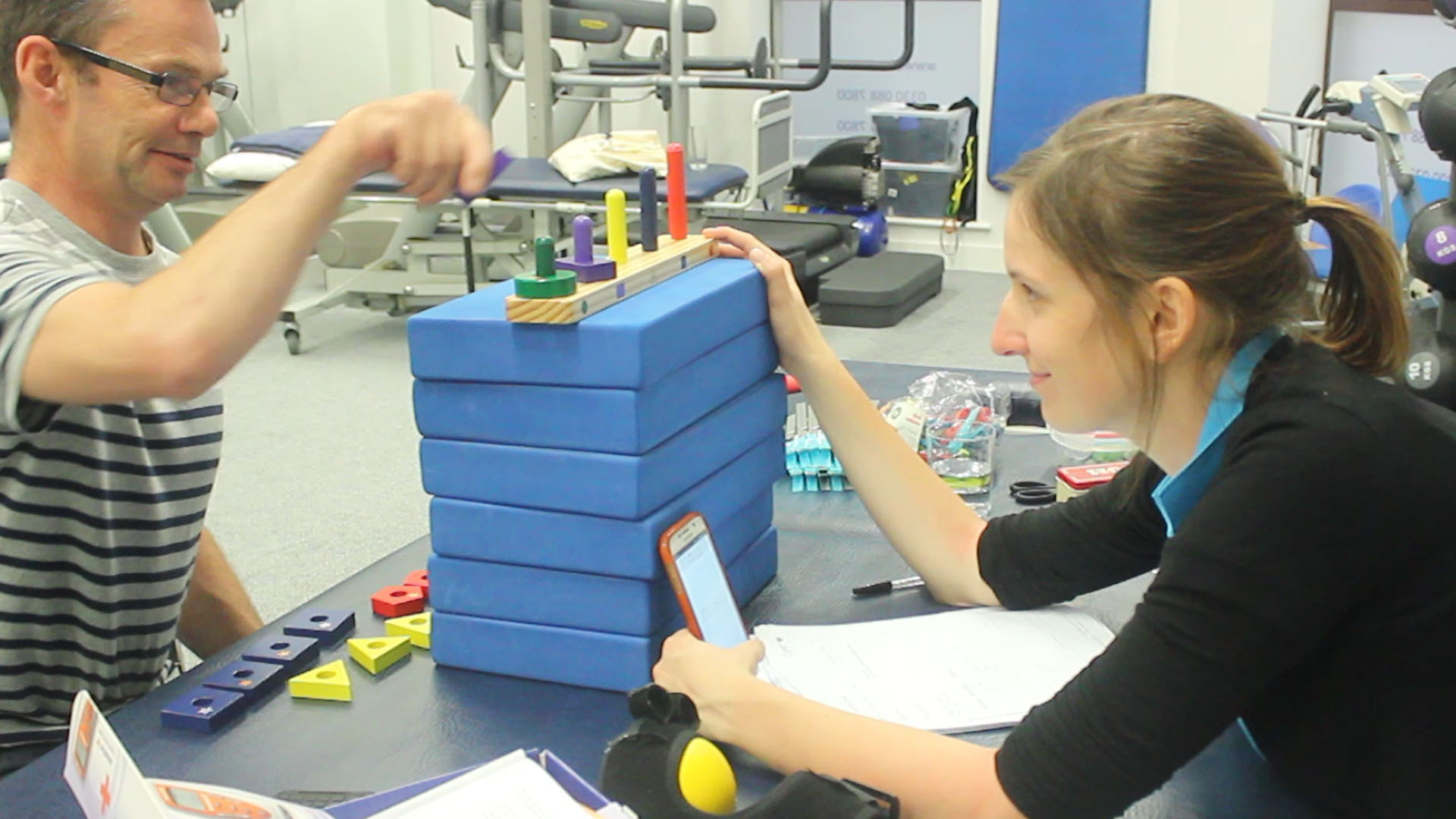 Andrew placing blocks on poles to test strength with grip.