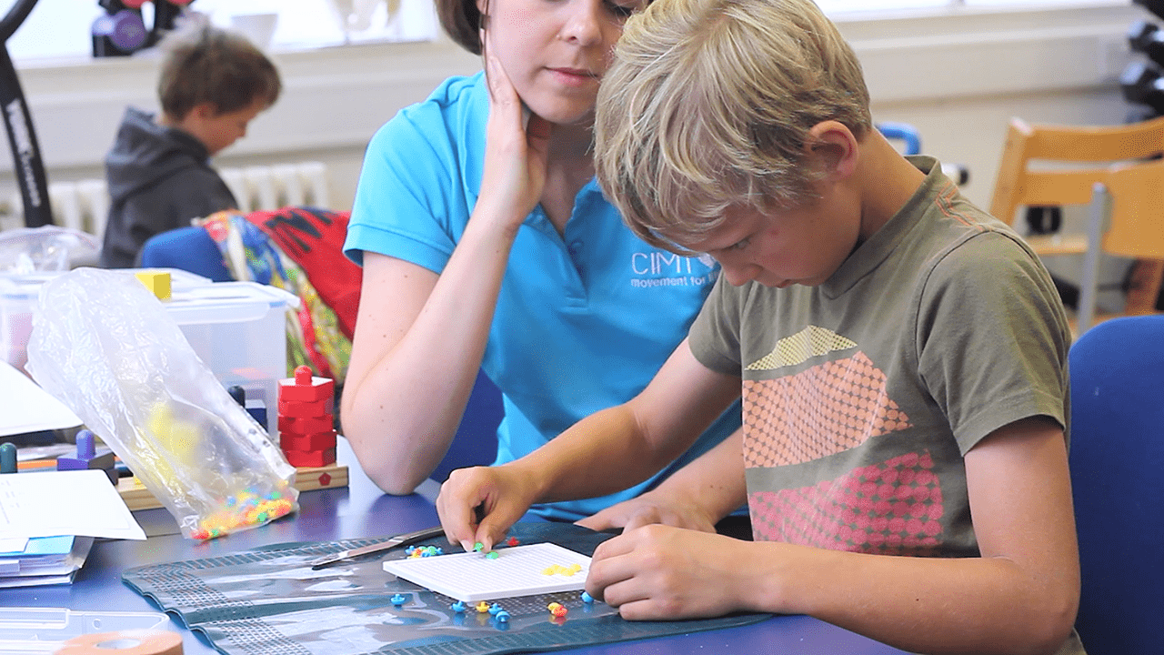 Caleb playing a game with his therapist.