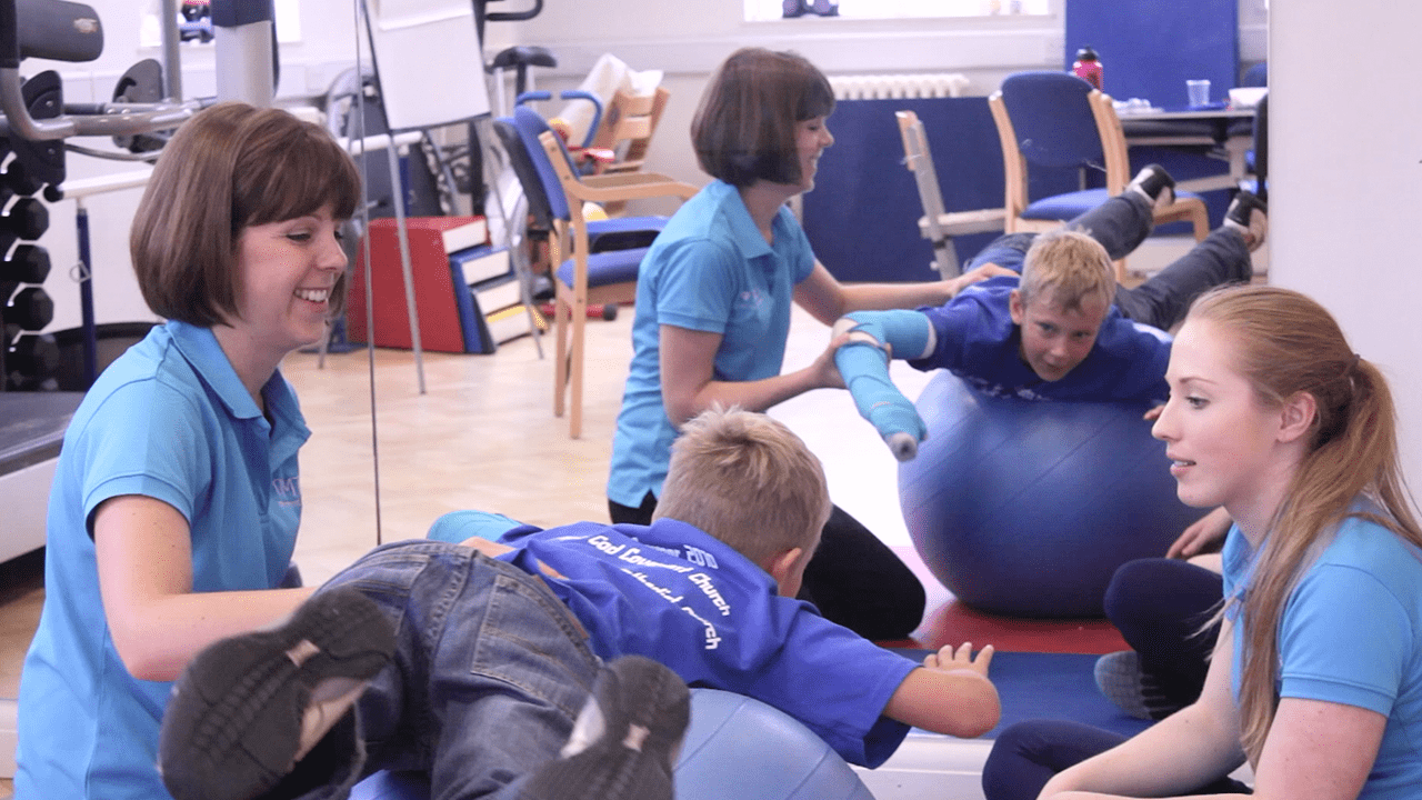 Caleb uses balancing ball during exercise.