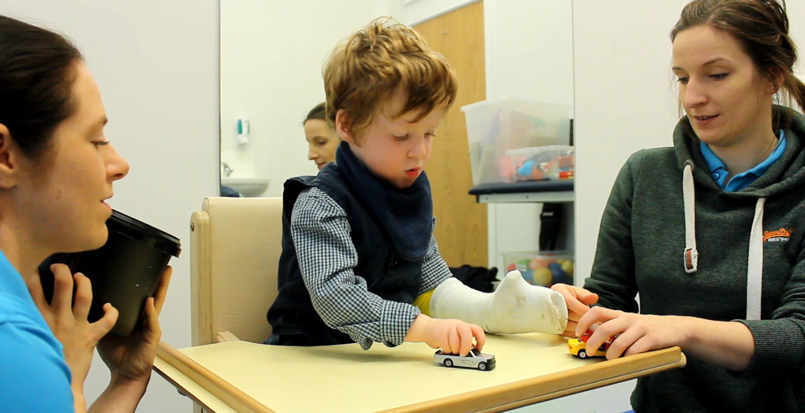 Freddie playing with toys with his cast on.