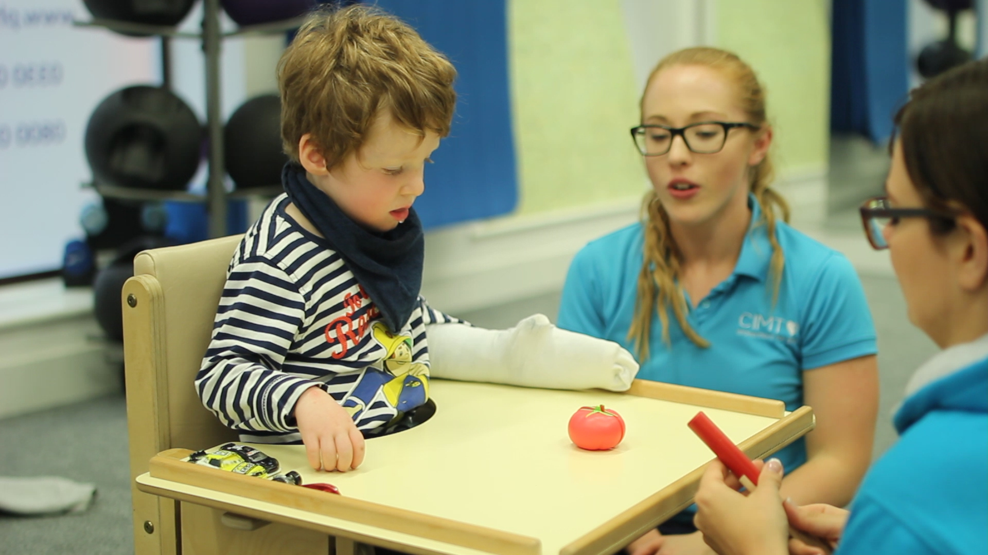 Freddie picking up objects using pincer grip.