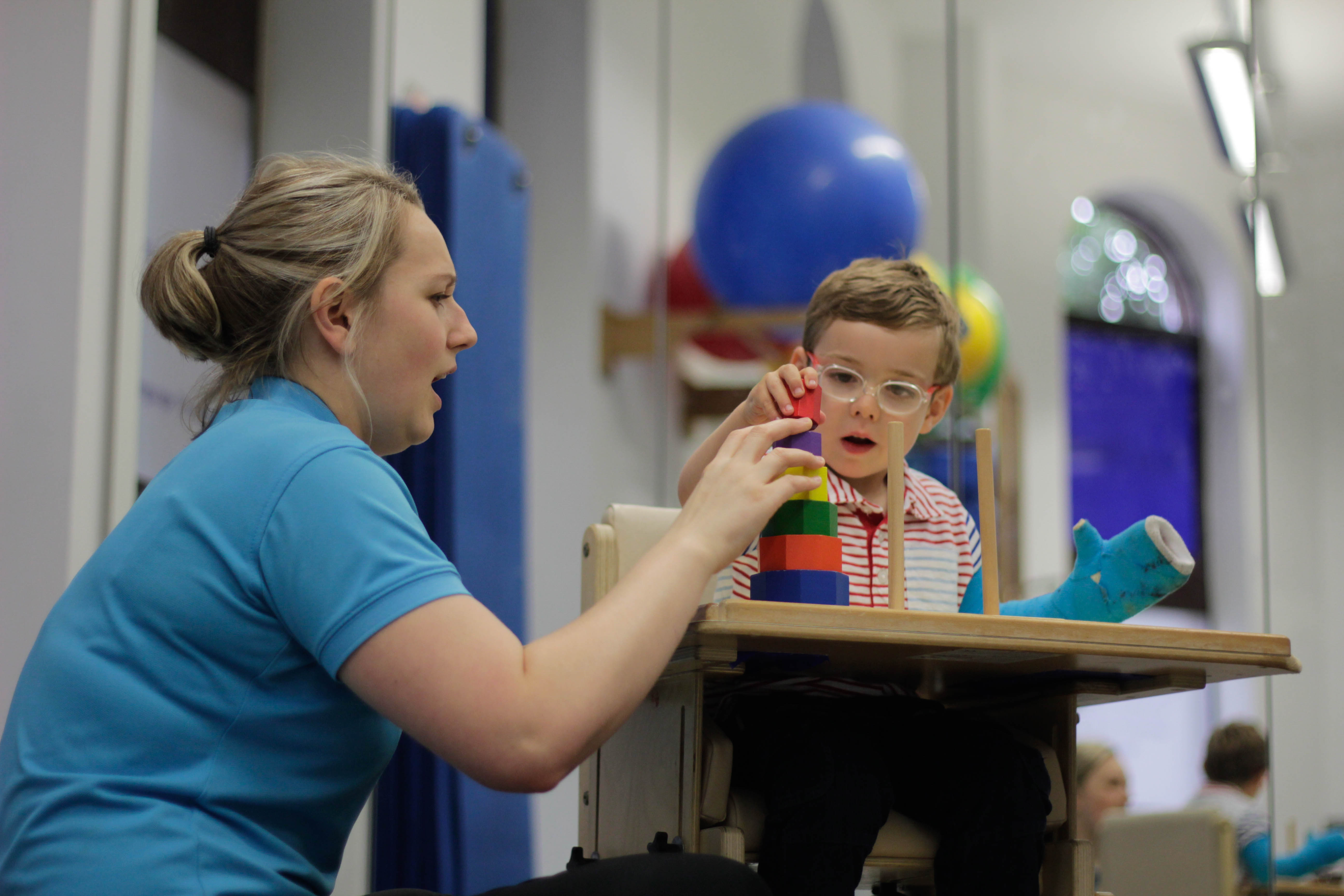 George playing with toys during CIMT treatment