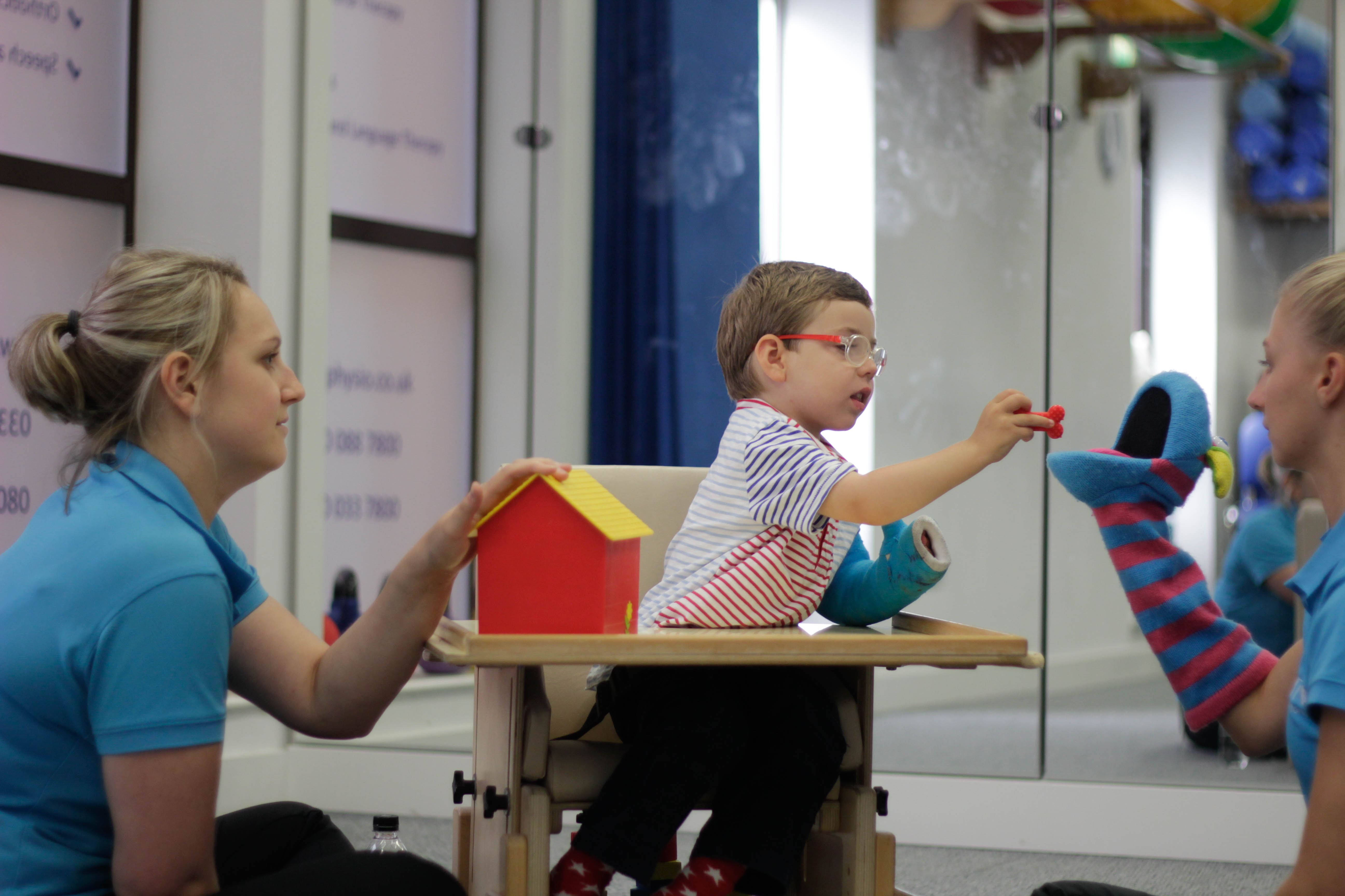 George bieng shown how to use the toys during CIMT treatment