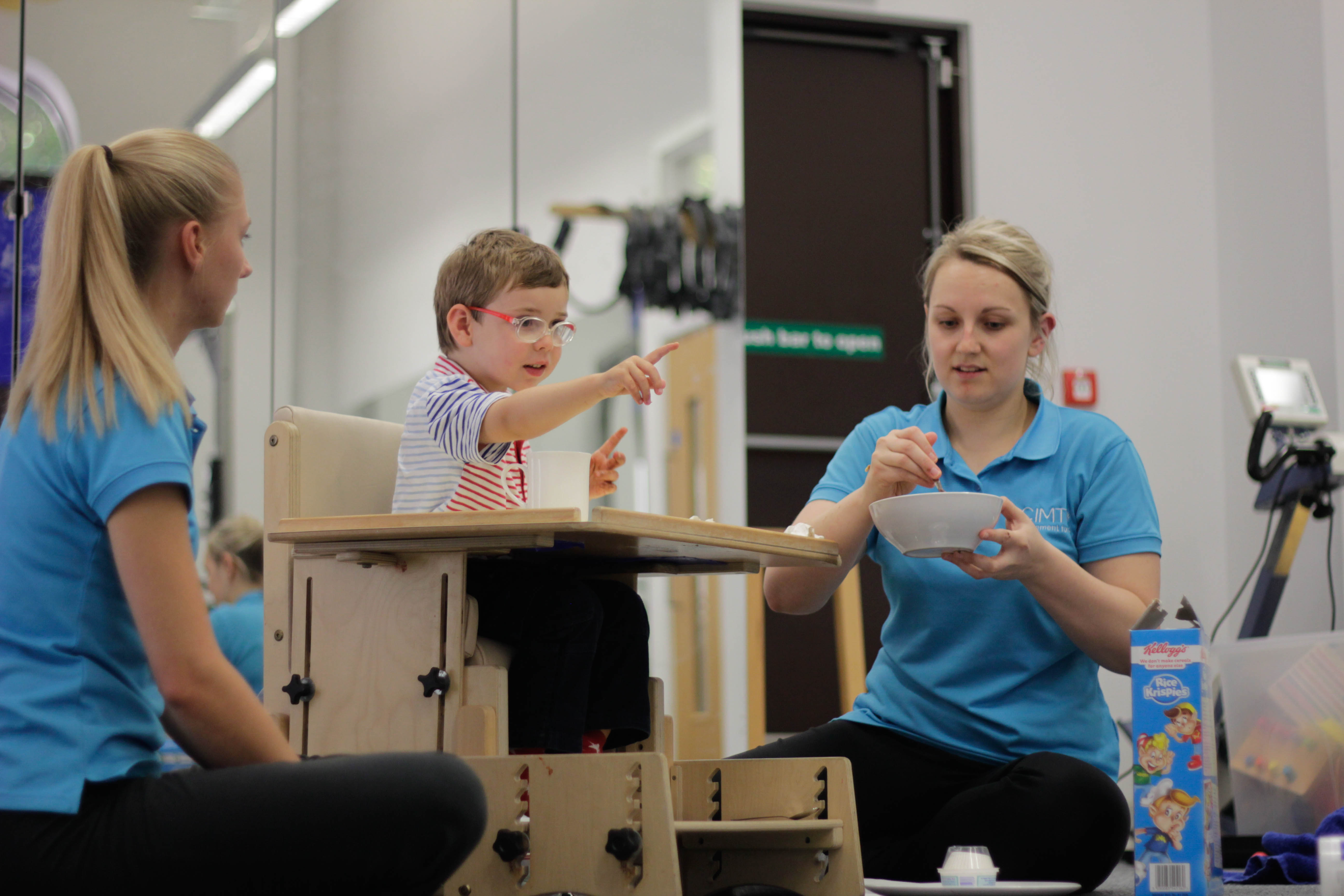 George looking over at CIMT therapist during treatment.