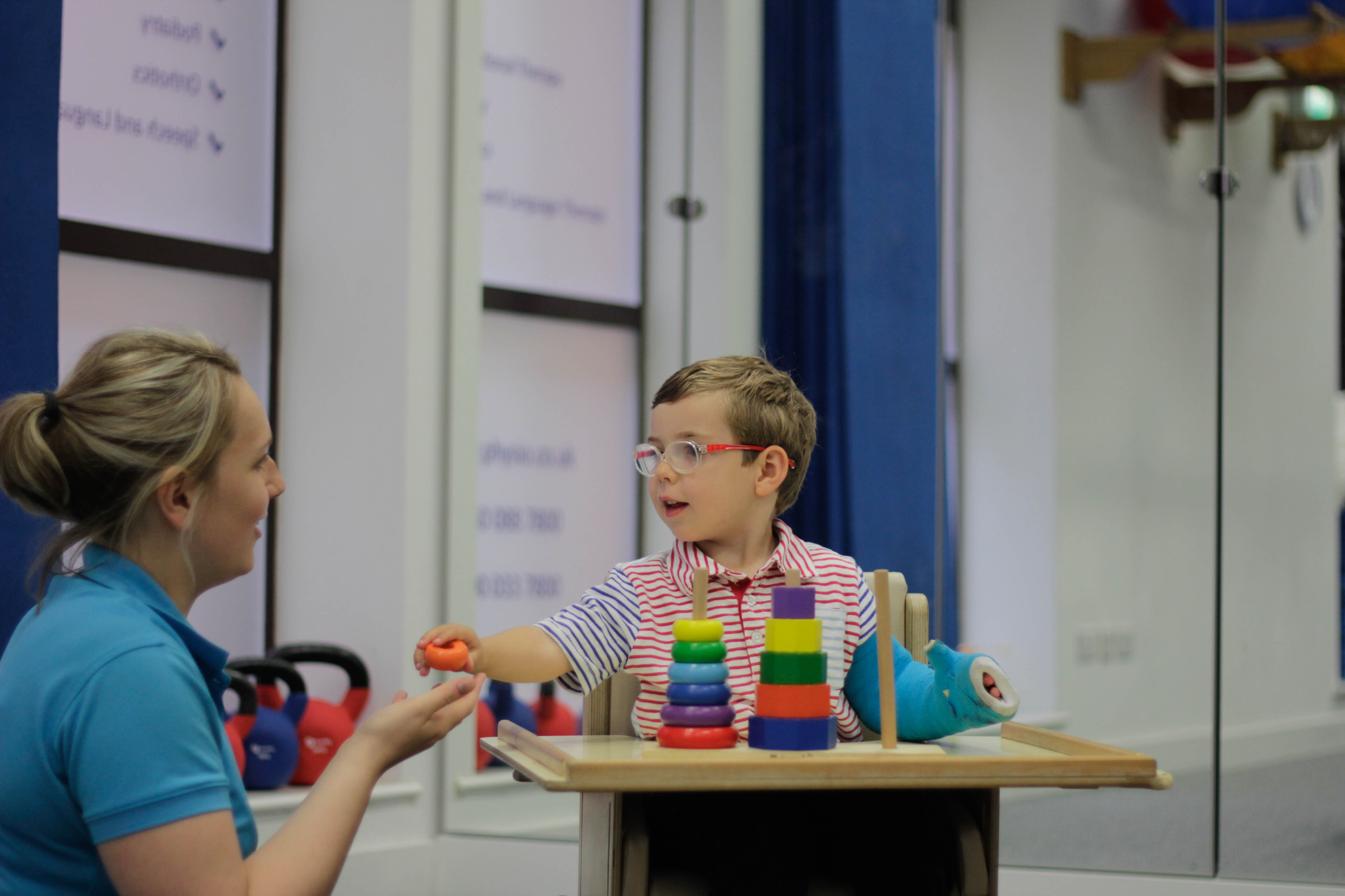 George playing with toys with CIMT therapists.