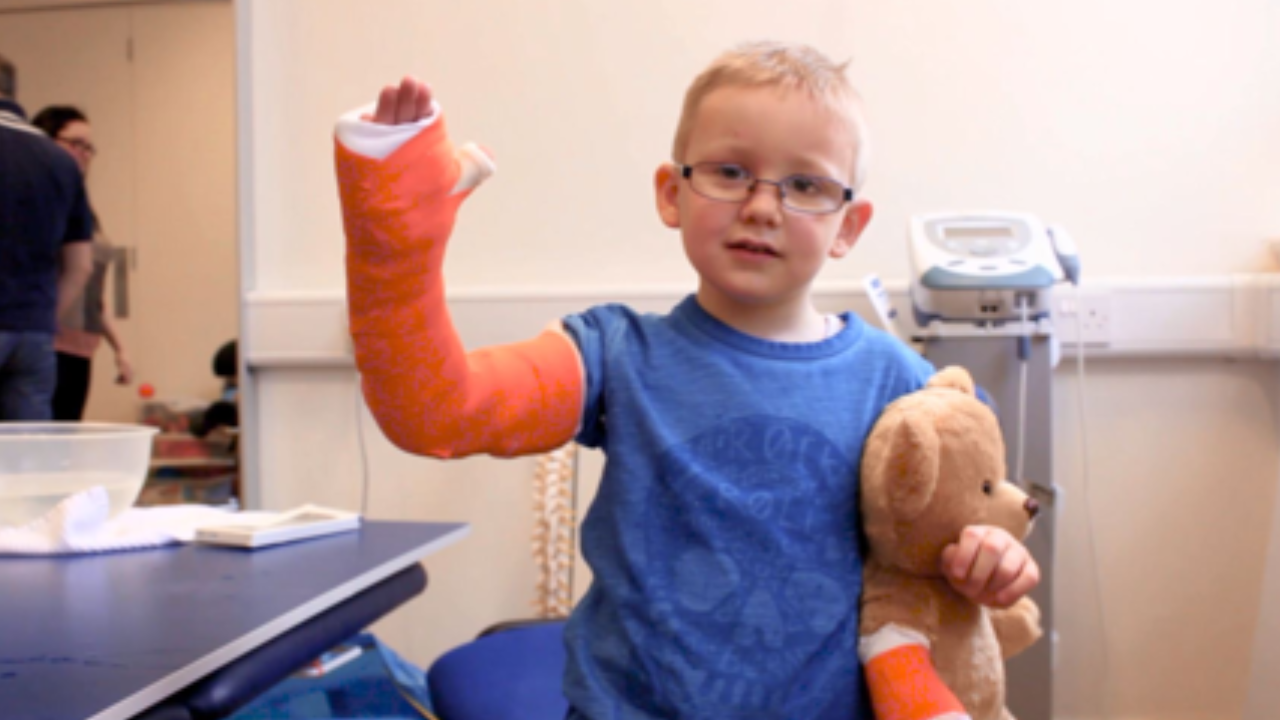 Harry with his cast on and his teddy.