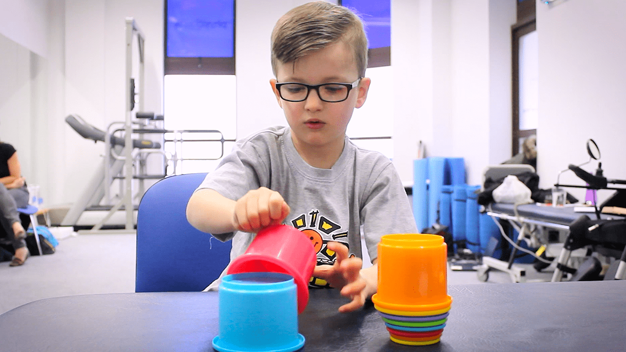 Jude stacking buckets as a challenge.