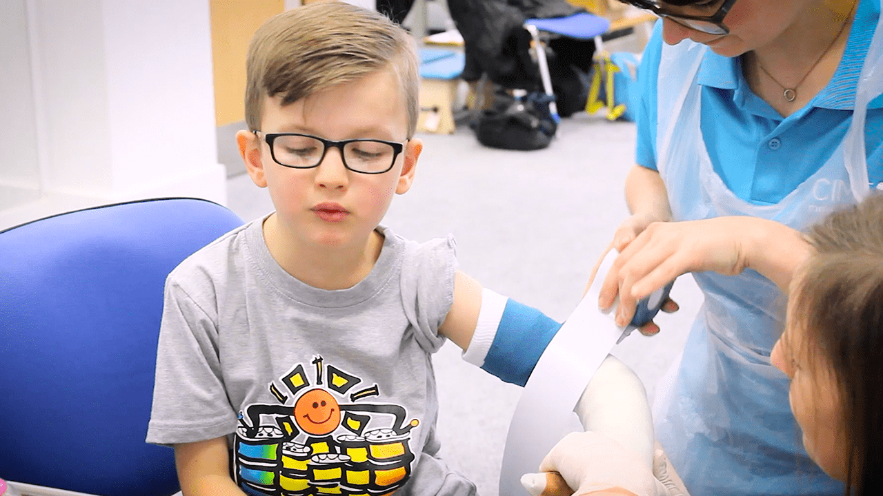 Jude sat while his cast is applied.