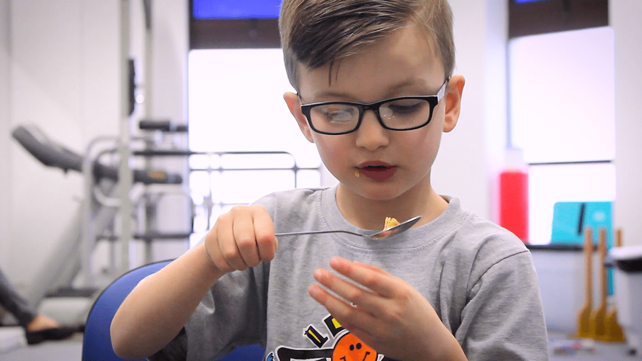 Jude eating using a spoon.