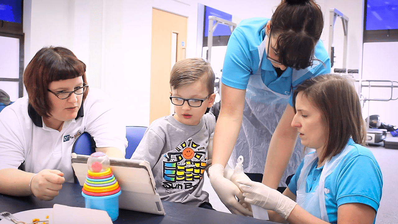 Jude watches video whilst his cast is applied.