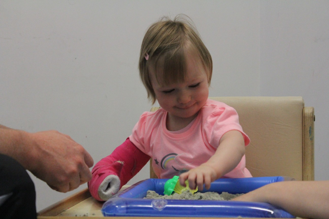 Leah playing with toys during CIMT treatment