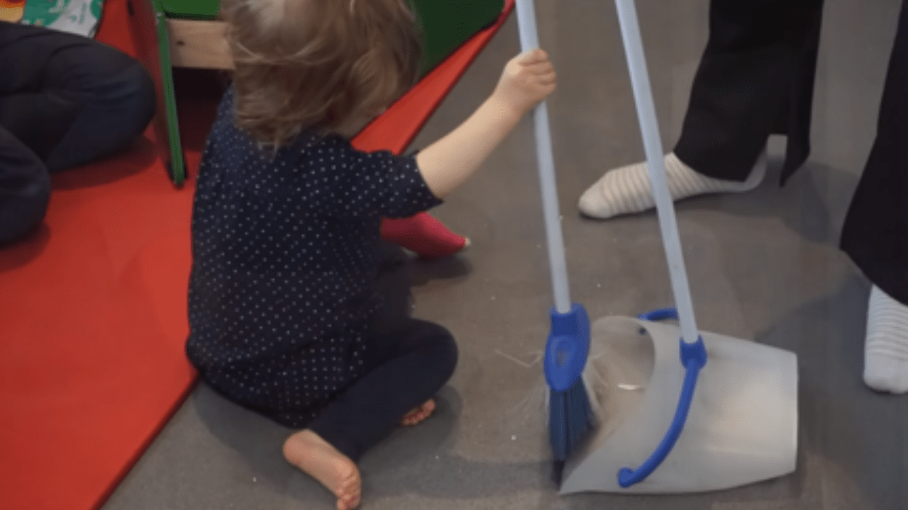 Lottie playing and practising cleaning.