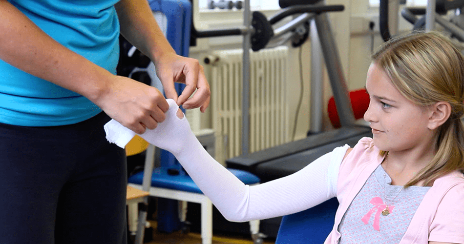 Lydia having a bandage applied to her hand.