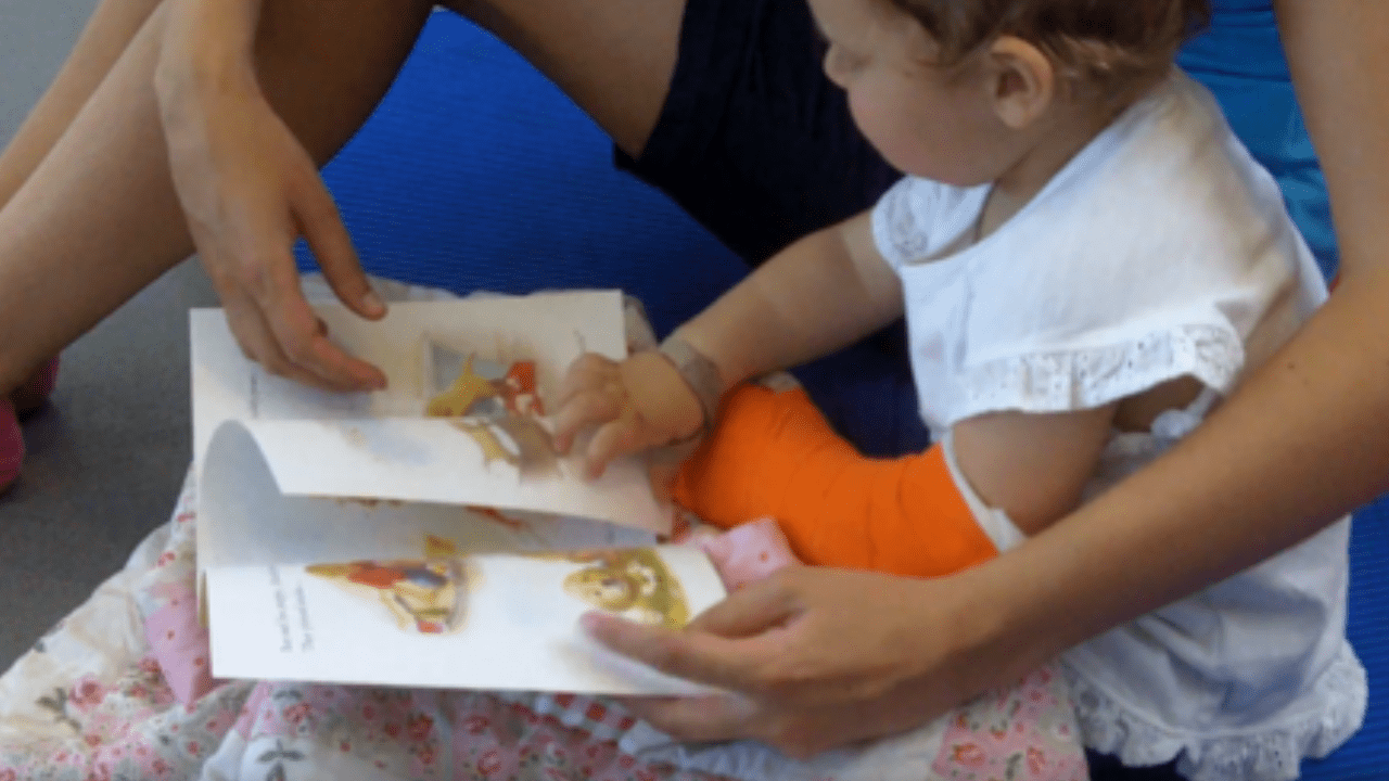 Molly reading a book during therapy.