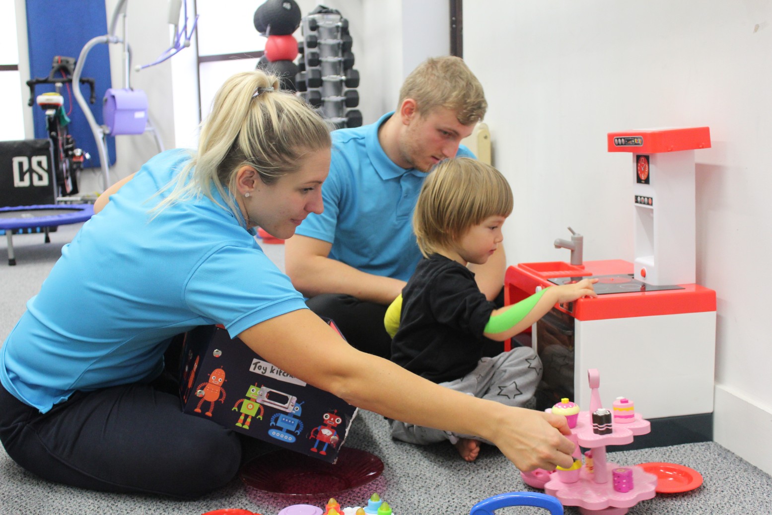 Reggie guided by CIMT therapist during treatment.