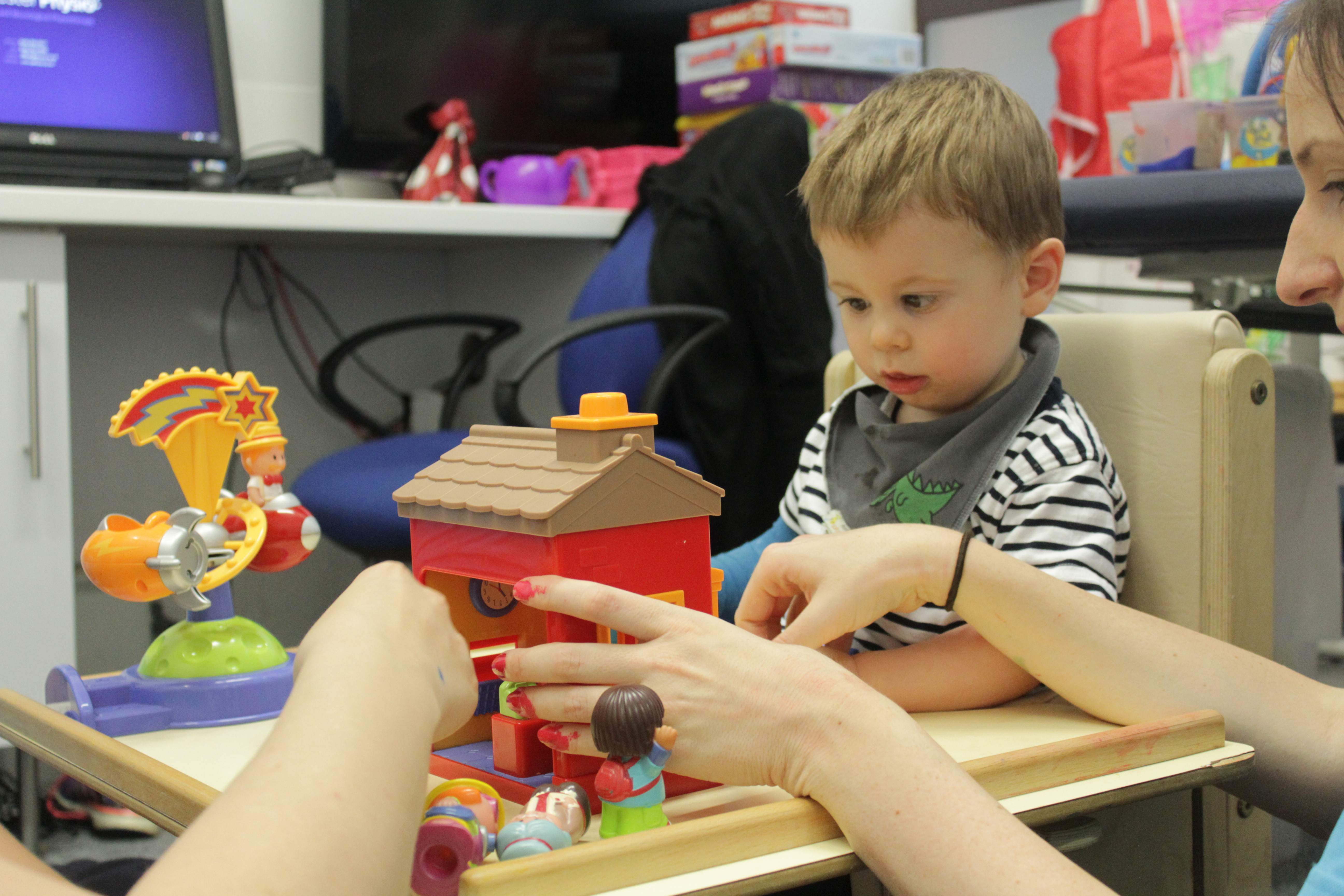 Thomas bieng shown how to use the toys during CIMT treatment