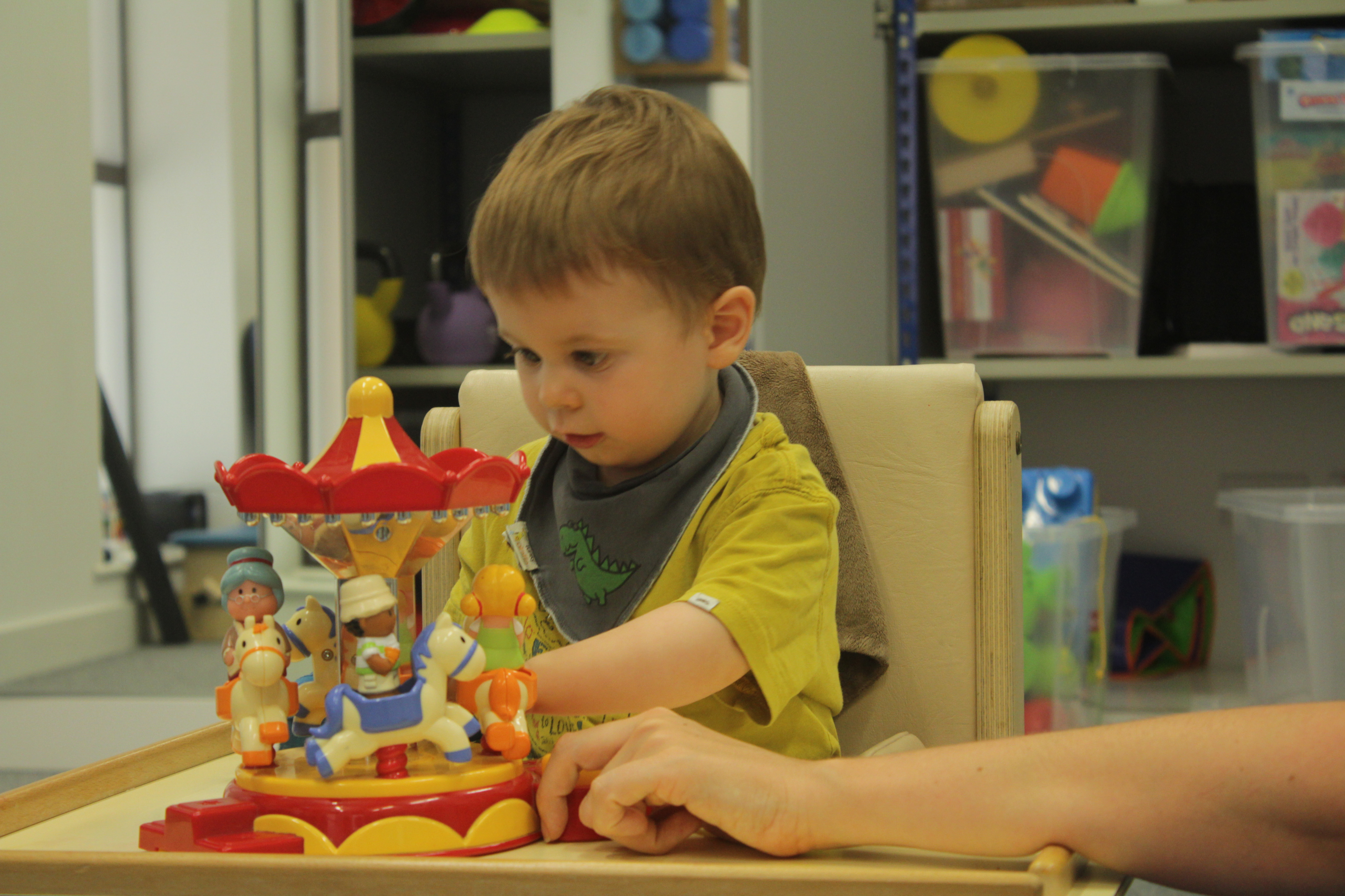 Thomas guided by CIMT therapist during treatment.