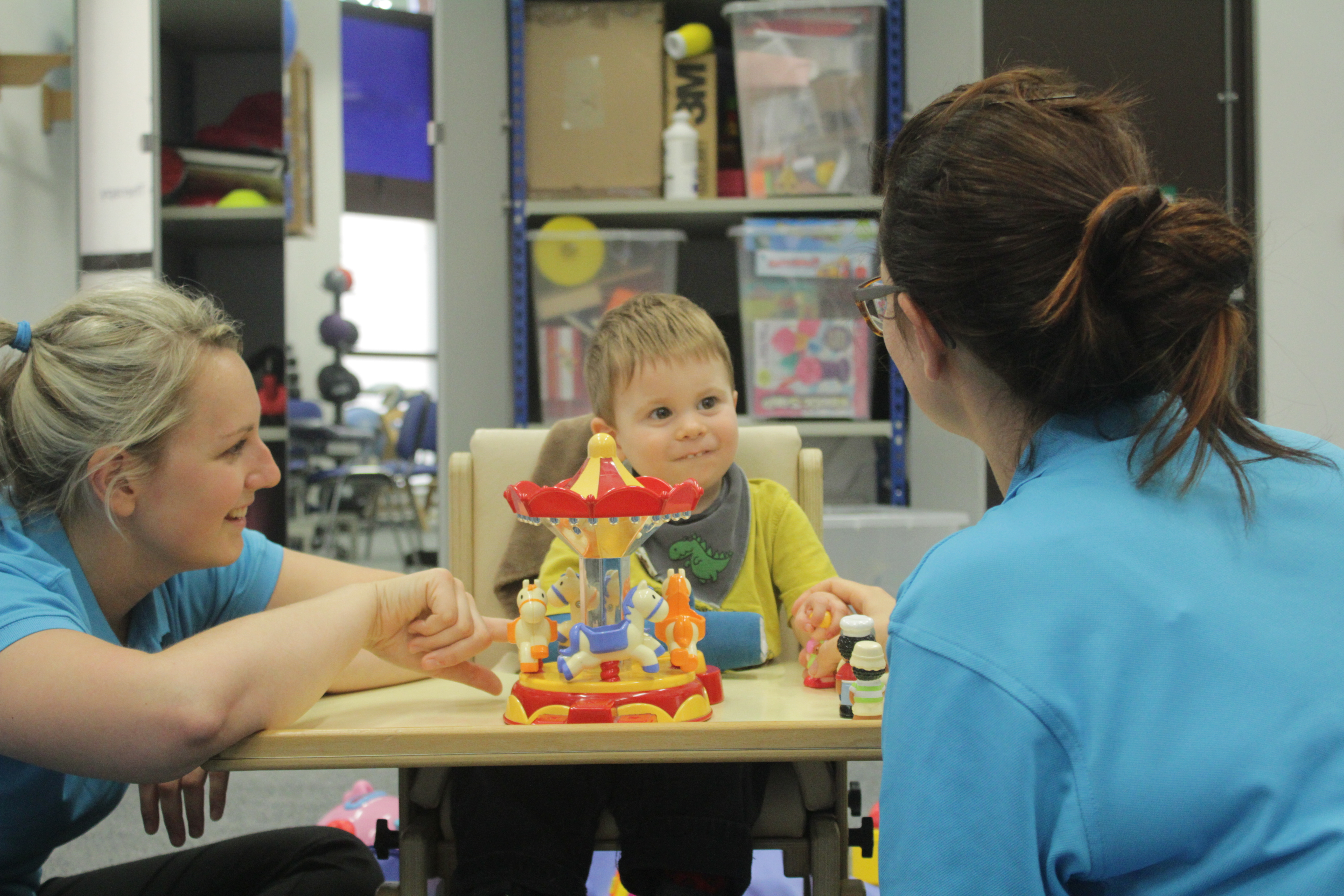 Thomas smiling at CIMT therapists.