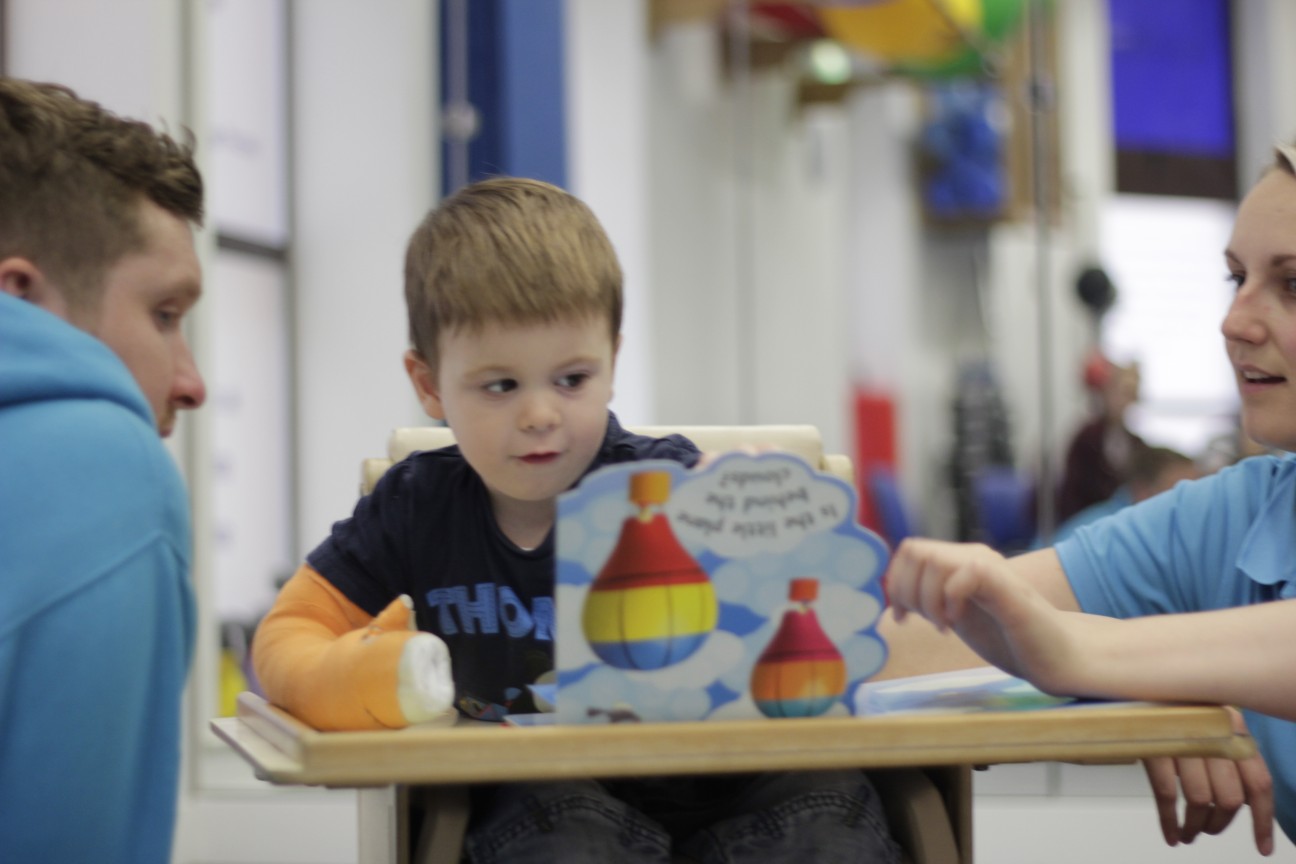 Thomas playing with shape blocks with CIMT therapists